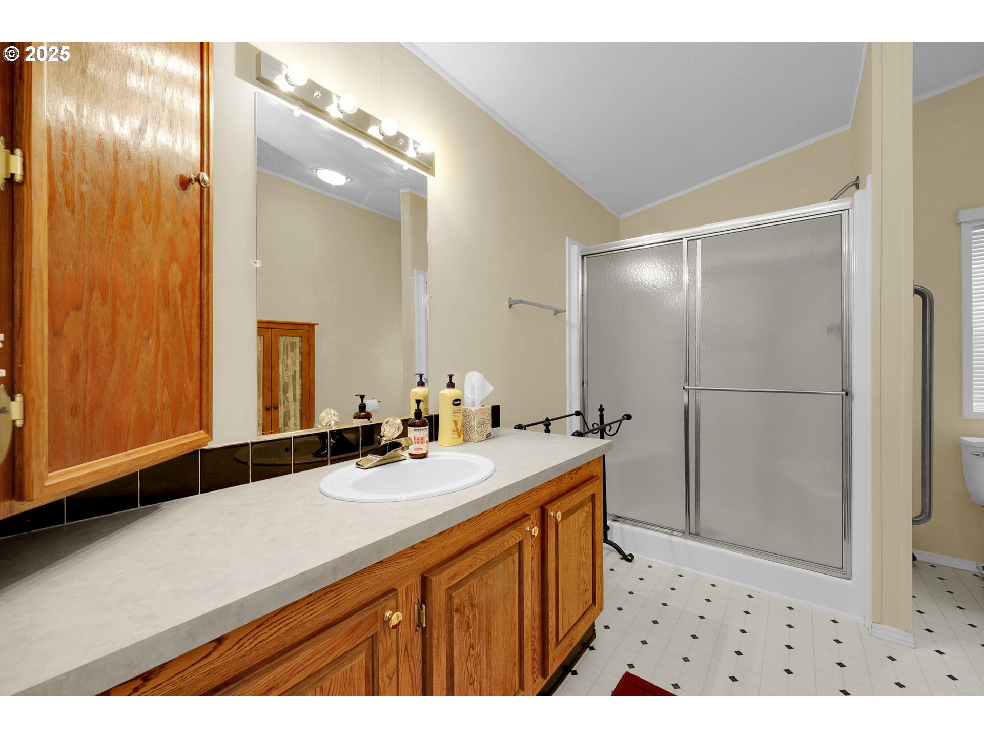 3900 Coburg Road, Unit 95 Eugene, OR 97408 - Photo 13 of 42 a bathroom with a sink a mirror and a shower