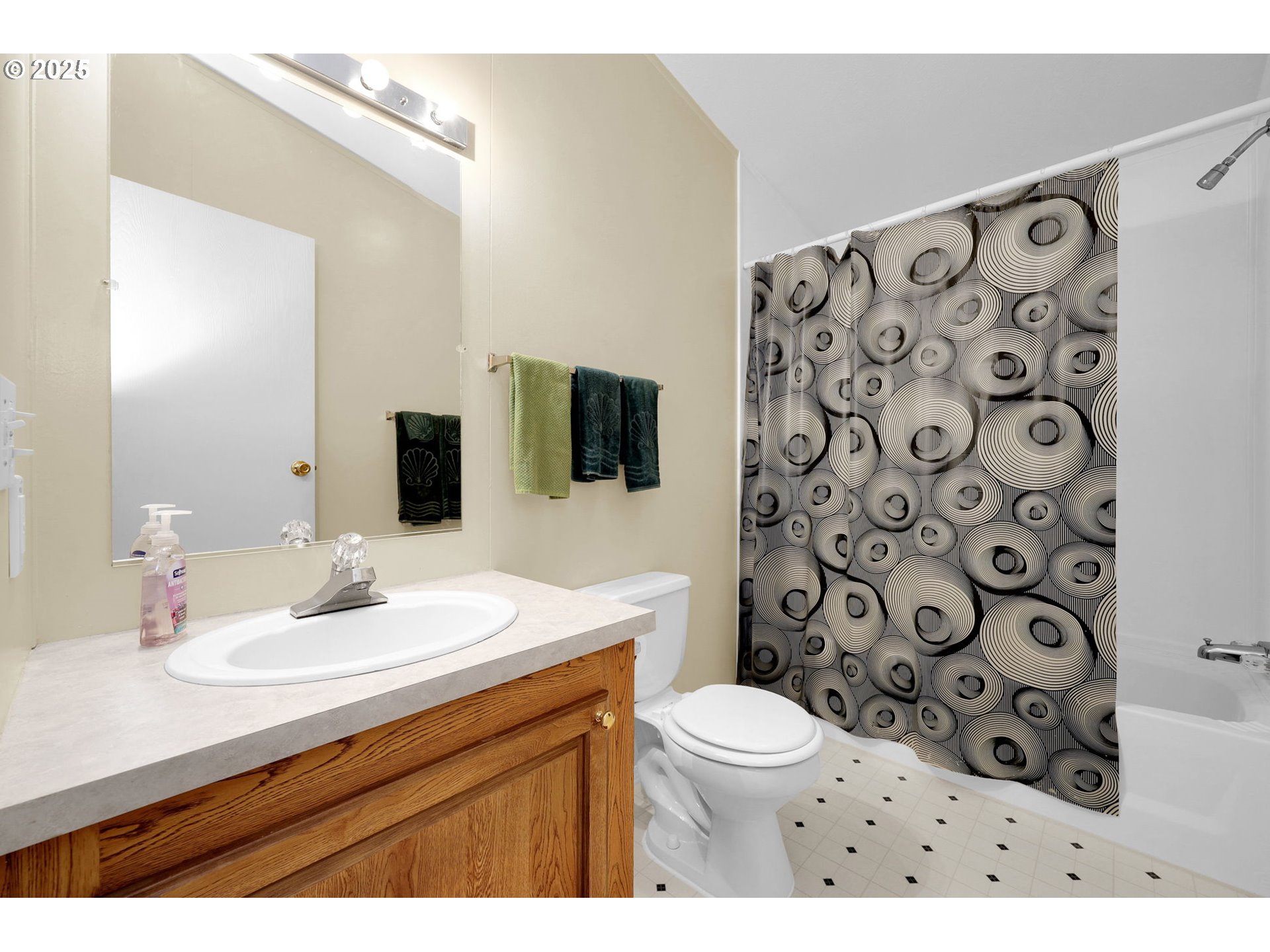 3900 Coburg Road, Unit 95 Eugene, OR 97408 - Photo 17 of 42 a bathroom with a sink toilet a mirror and shower curtain