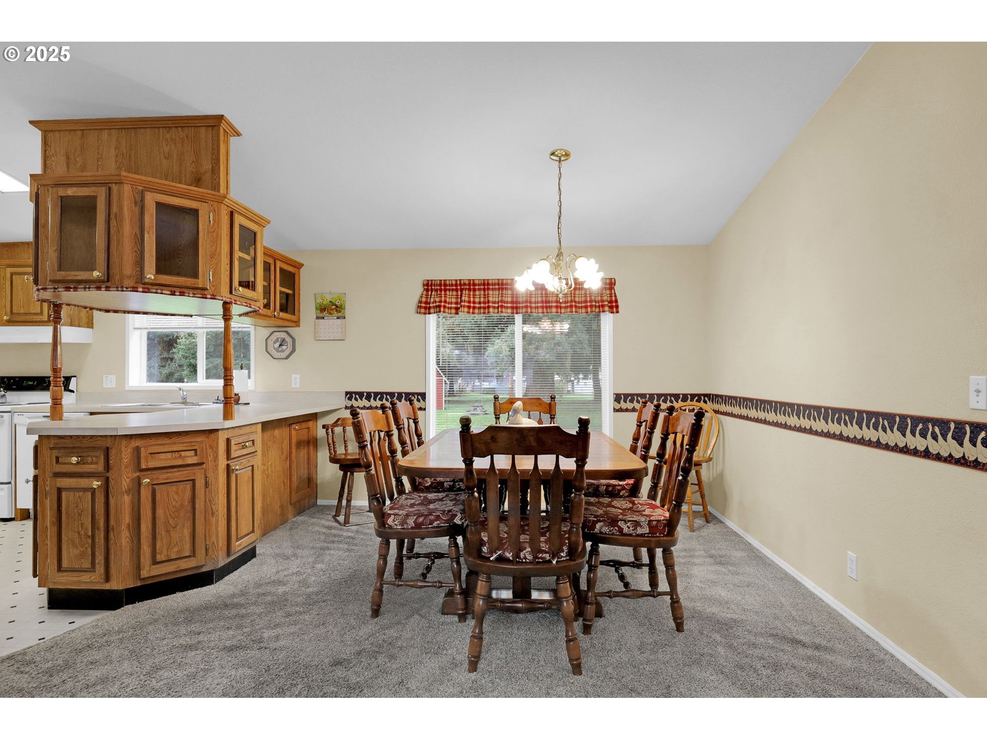 3900 Coburg Road, Unit 95 Eugene, OR 97408 - Photo 25 of 42 a view of a dining room with furniture window and wooden floor