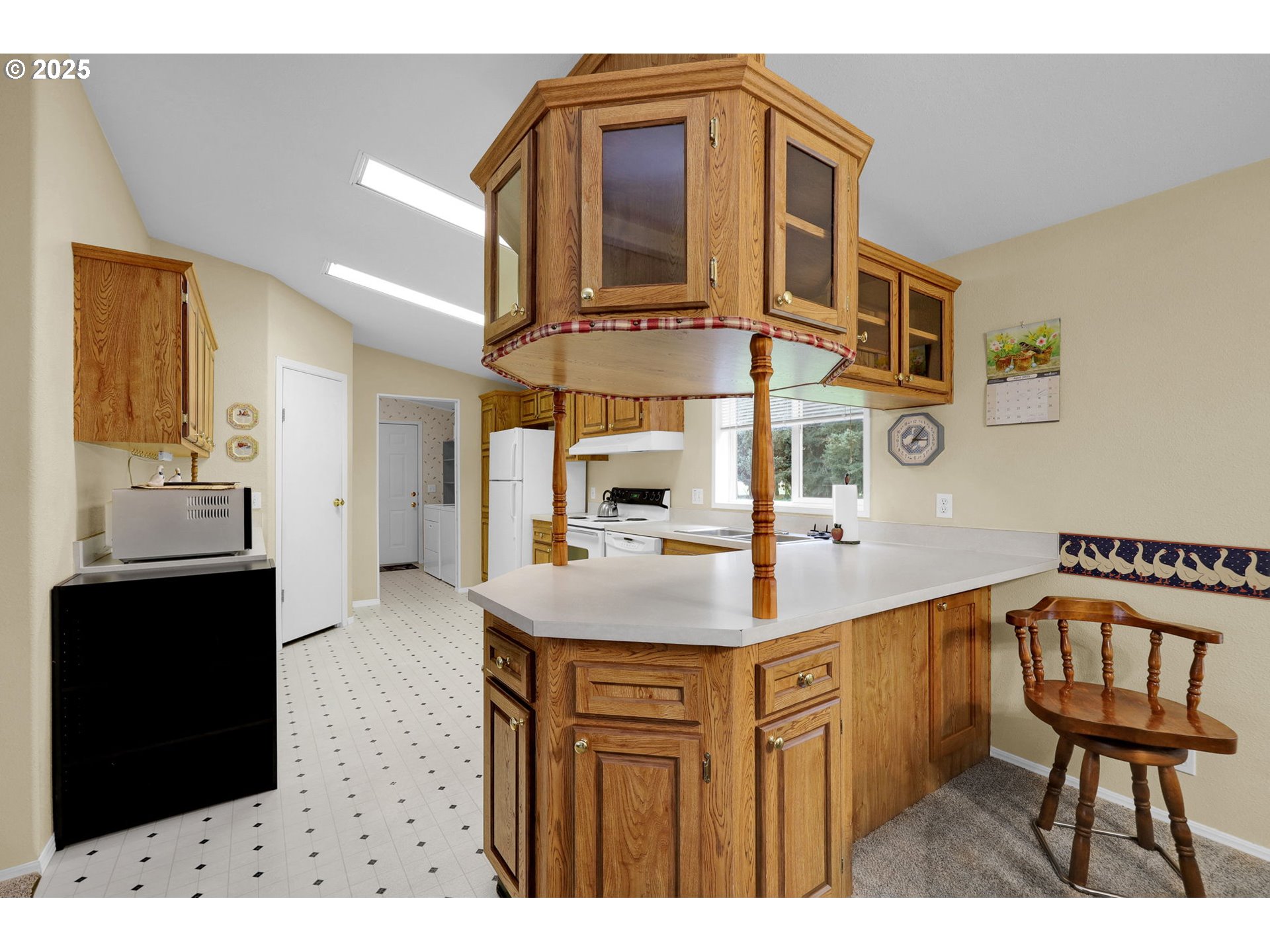 3900 Coburg Road, Unit 95 Eugene, OR 97408 - Photo 3 of 42 a view of a kitchen area with furniture and wooden floor