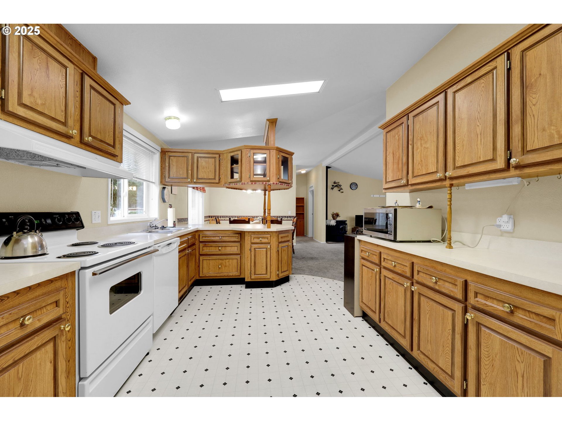 3900 Coburg Road, Unit 95 Eugene, OR 97408 - Photo 6 of 42 a kitchen with stainless steel appliances kitchen island granite countertop a sink and cabinets