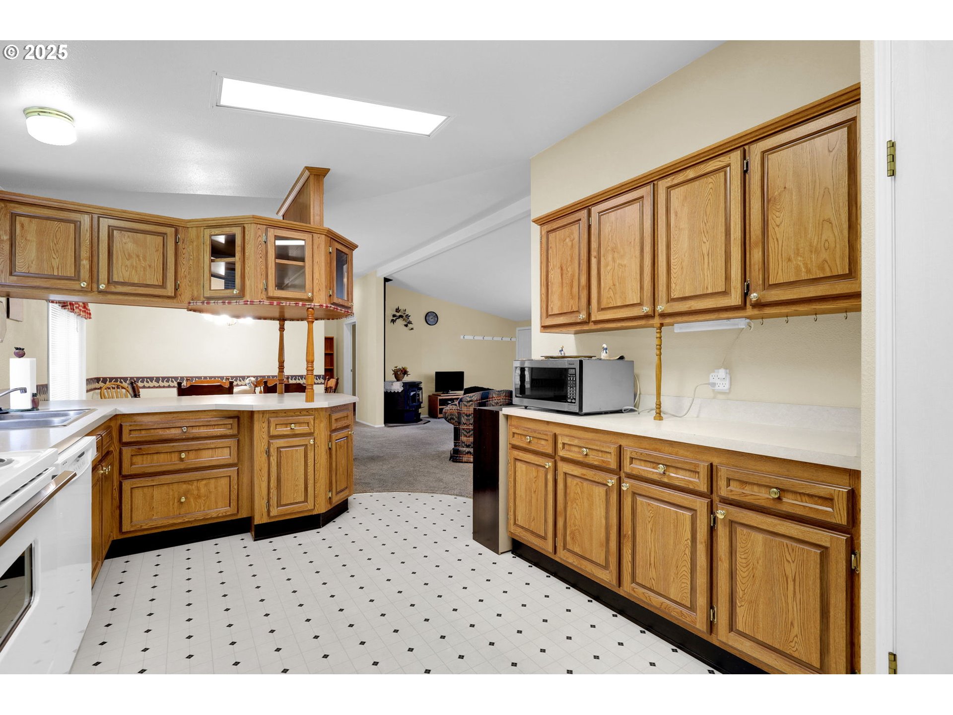 3900 Coburg Road, Unit 95 Eugene, OR 97408 - Photo 7 of 42 a kitchen with stainless steel appliances kitchen island granite countertop a sink dishwasher stove and cabinets