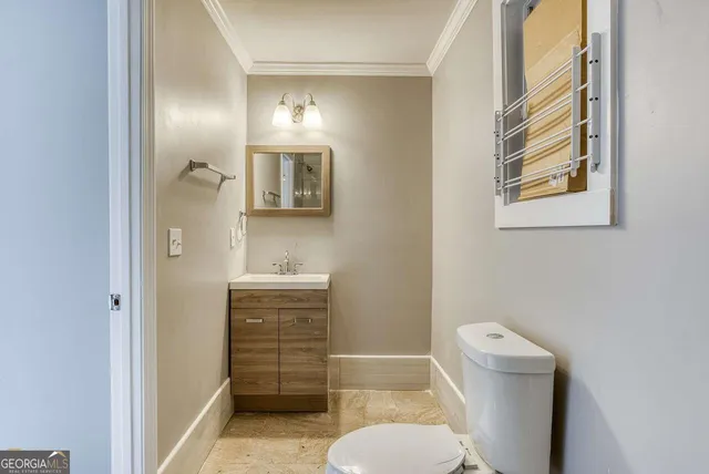 a bathroom with a toilet a sink and mirror