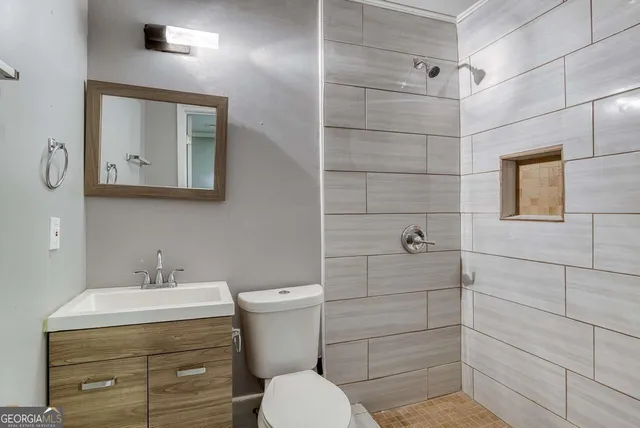 a bathroom with a toilet sink and shower