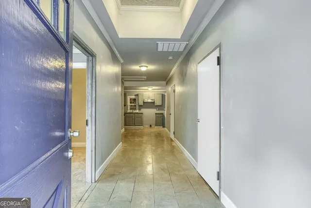 a view of a hallway with wooden floor