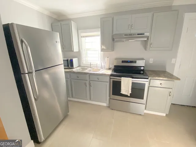 a white refrigerator freezer sitting inside of a kitchen