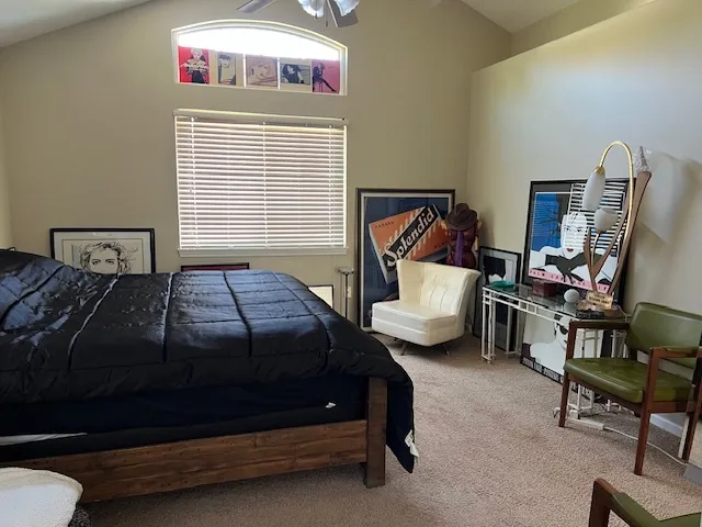 a bedroom with a bed chair and window