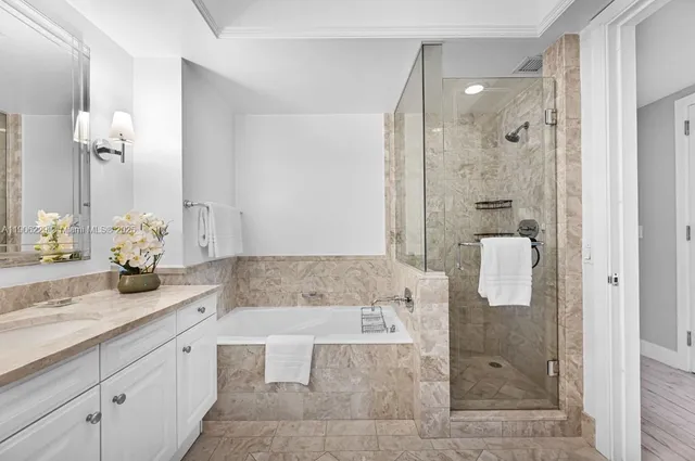 a bathroom with a granite countertop sink a shower and a mirror