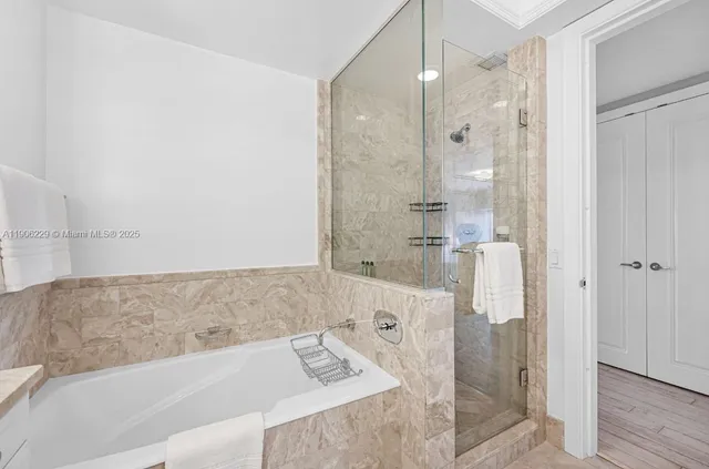 a bathroom with a bathtub and shower