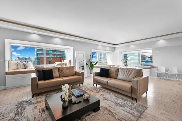 a living room with furniture and a large window