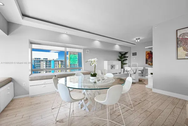 a view of a dining room with furniture and wooden floor
