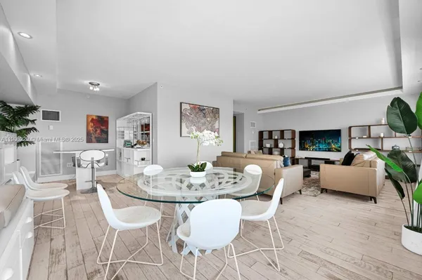 a dining room with furniture and wooden floor