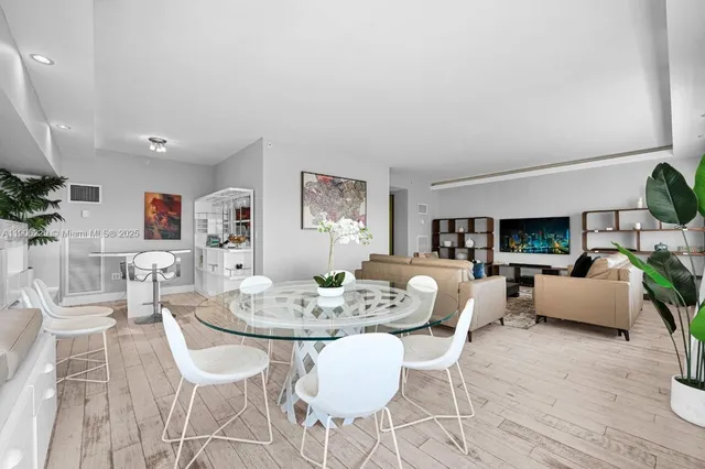 a dining room with furniture and wooden floor