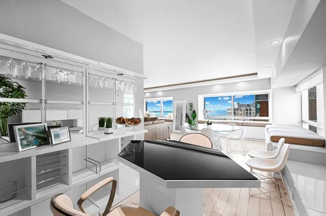 a living room with furniture a flat screen tv and large window