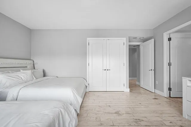 a bedroom with a bed and a shower