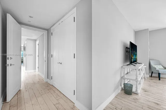 a view of a livingroom with wooden floor and a flat screen tv