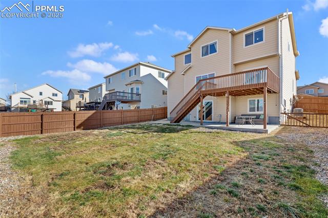 4540 Sierra Rica Road Colorado Springs, CO 80911 - Photo 7 of 42 Back of property featuring a patio area, a fenced backyard, a deck, a residential view, and stairs