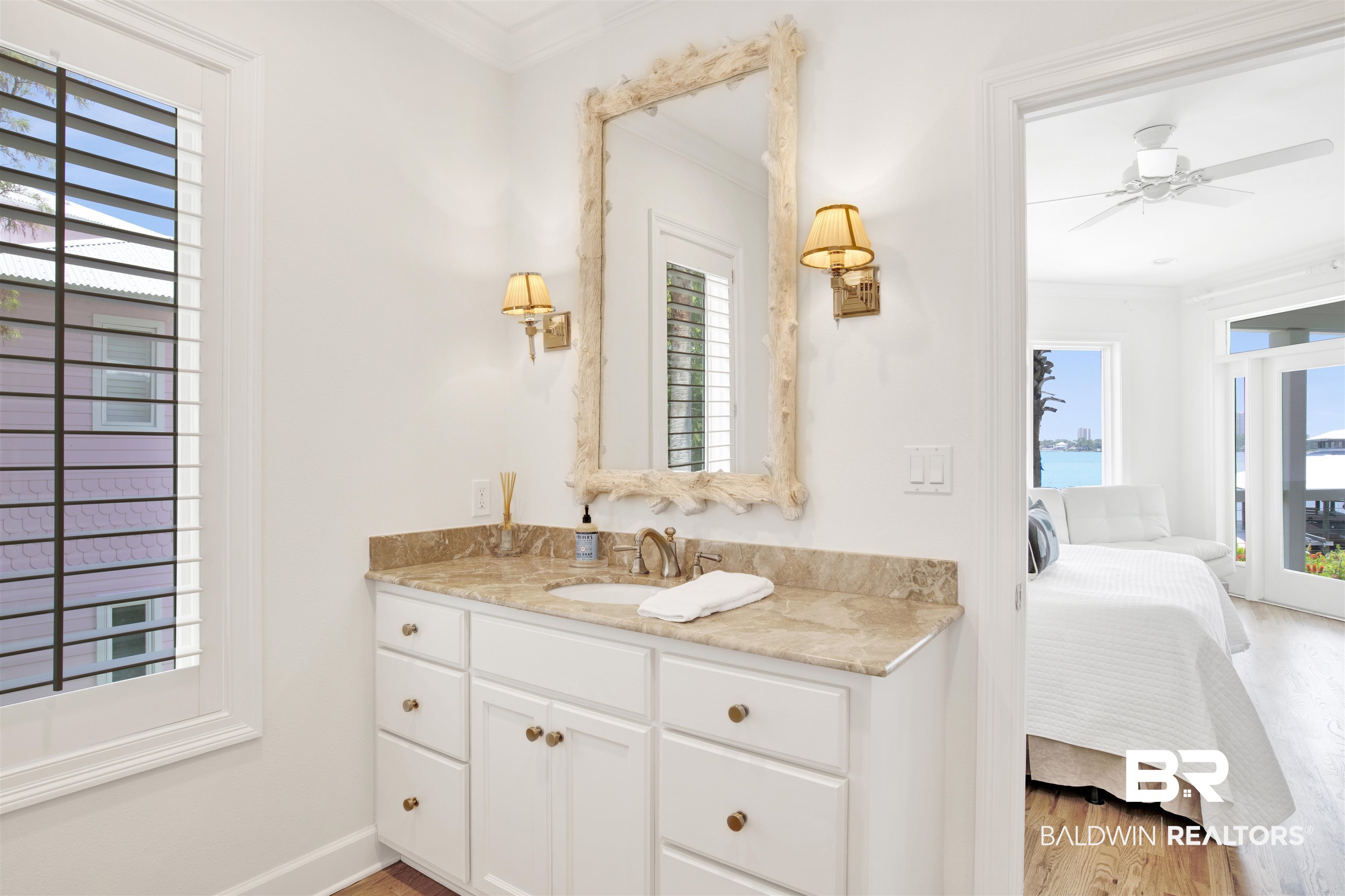 33400 River Road Orange Beach, AL 36561 - Photo 38 of 72 Bathroom featuring a healthy amount of sunlight, vanity, and hardwood / wood-style floors