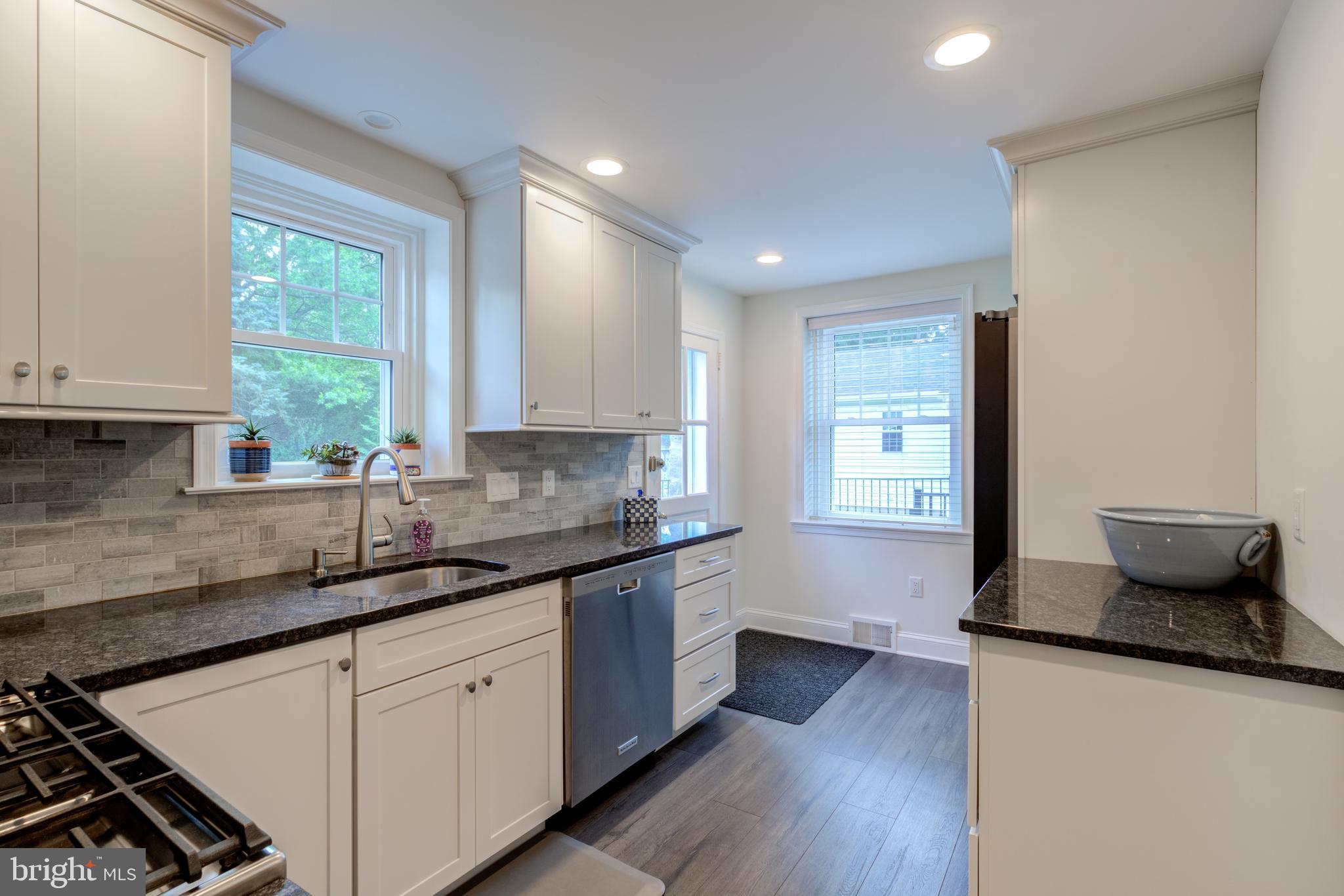 51 Mansion Road Springfield, PA 19064 - Photo 16 of 45 a kitchen with stainless steel appliances granite countertop wooden floors and sink