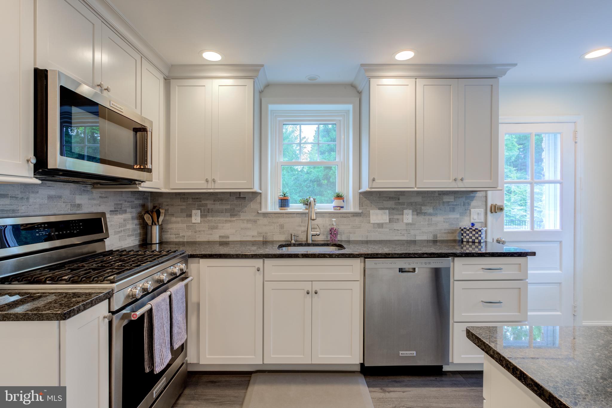 51 Mansion Road Springfield, PA 19064 - Photo 18 of 45 a kitchen with granite countertop white cabinets stainless steel appliances and a sink