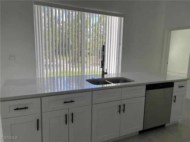 a kitchen with a sink and cabinets