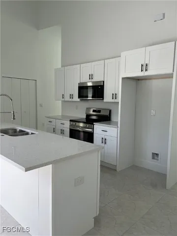 a kitchen with a sink a stove and refrigerator