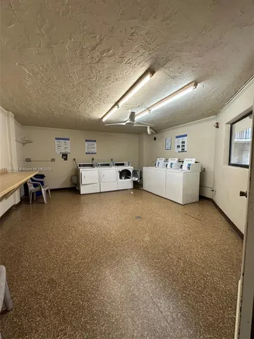 a living room with furniture and white walls