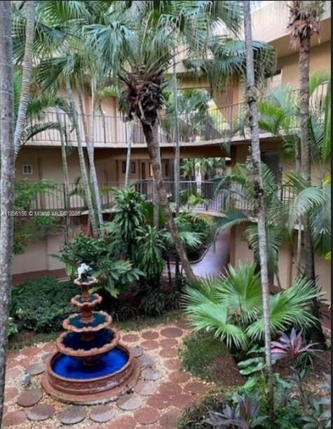 8025 Southwest 107th Avenue, Unit 112 Miami, FL 33173 - Photo 17 of 30 a view of a house with a yard and plants