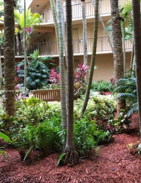 8025 Southwest 107th Avenue, Unit 112 Miami, FL 33173 - Photo 18 of 30 a bunch of flowers in front of house