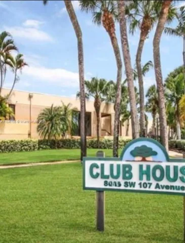 a view of a house with a yard and sitting area