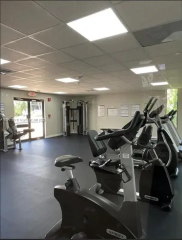 a room with gym equipment and a large window