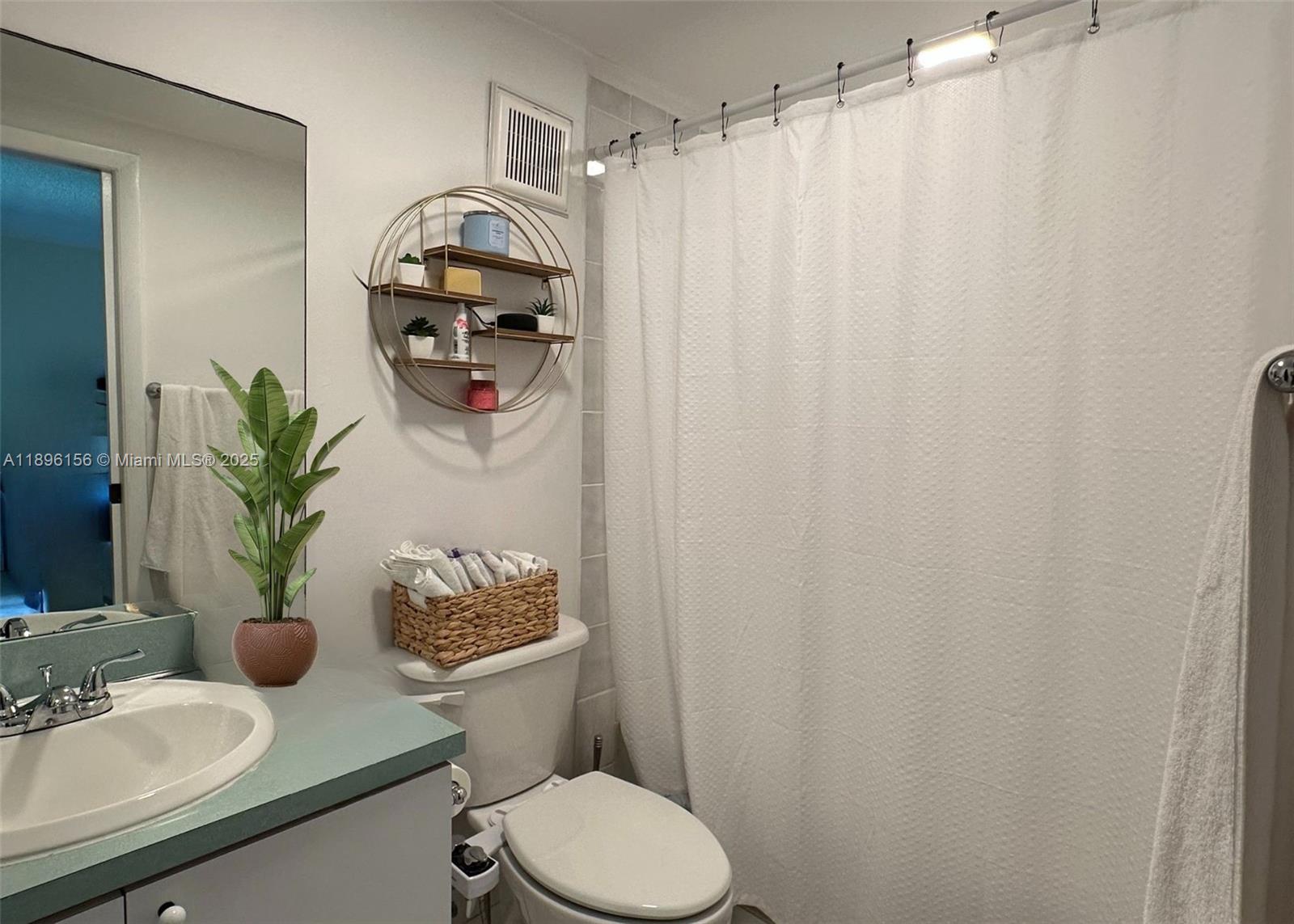 8025 Southwest 107th Avenue, Unit 112 Miami, FL 33173 - Photo 7 of 30 a bathroom with a sink toilet and mirror