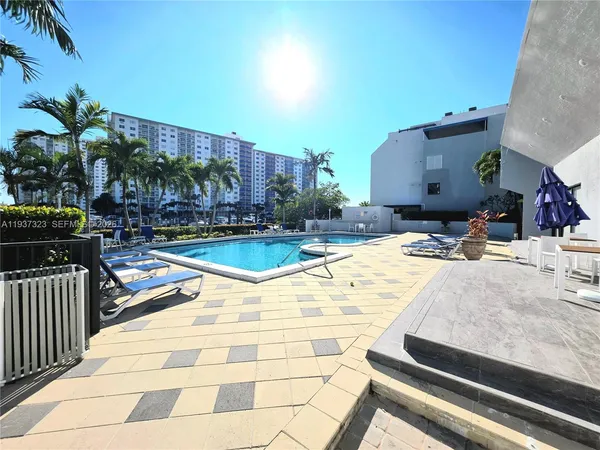 a swimming pool with outdoor seating and yard
