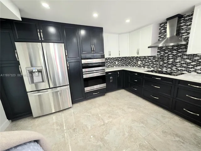 a kitchen with a refrigerator and a sink