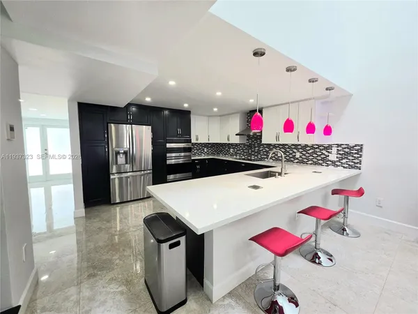 a kitchen with a refrigerator and a sink