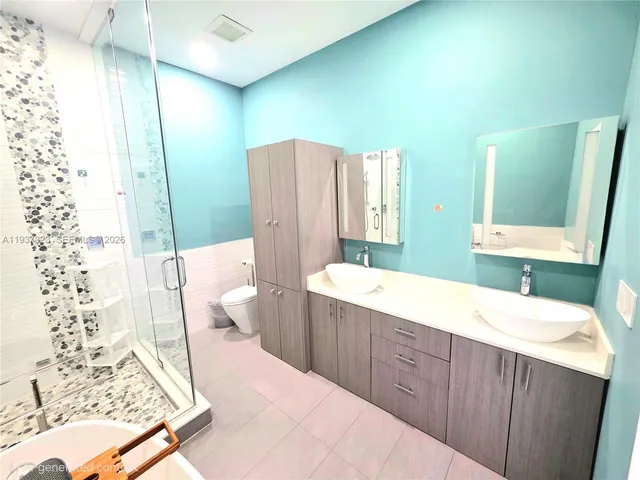 a bathroom with a bathtub and shower