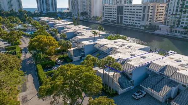 an aerial view of multiple houses with yard