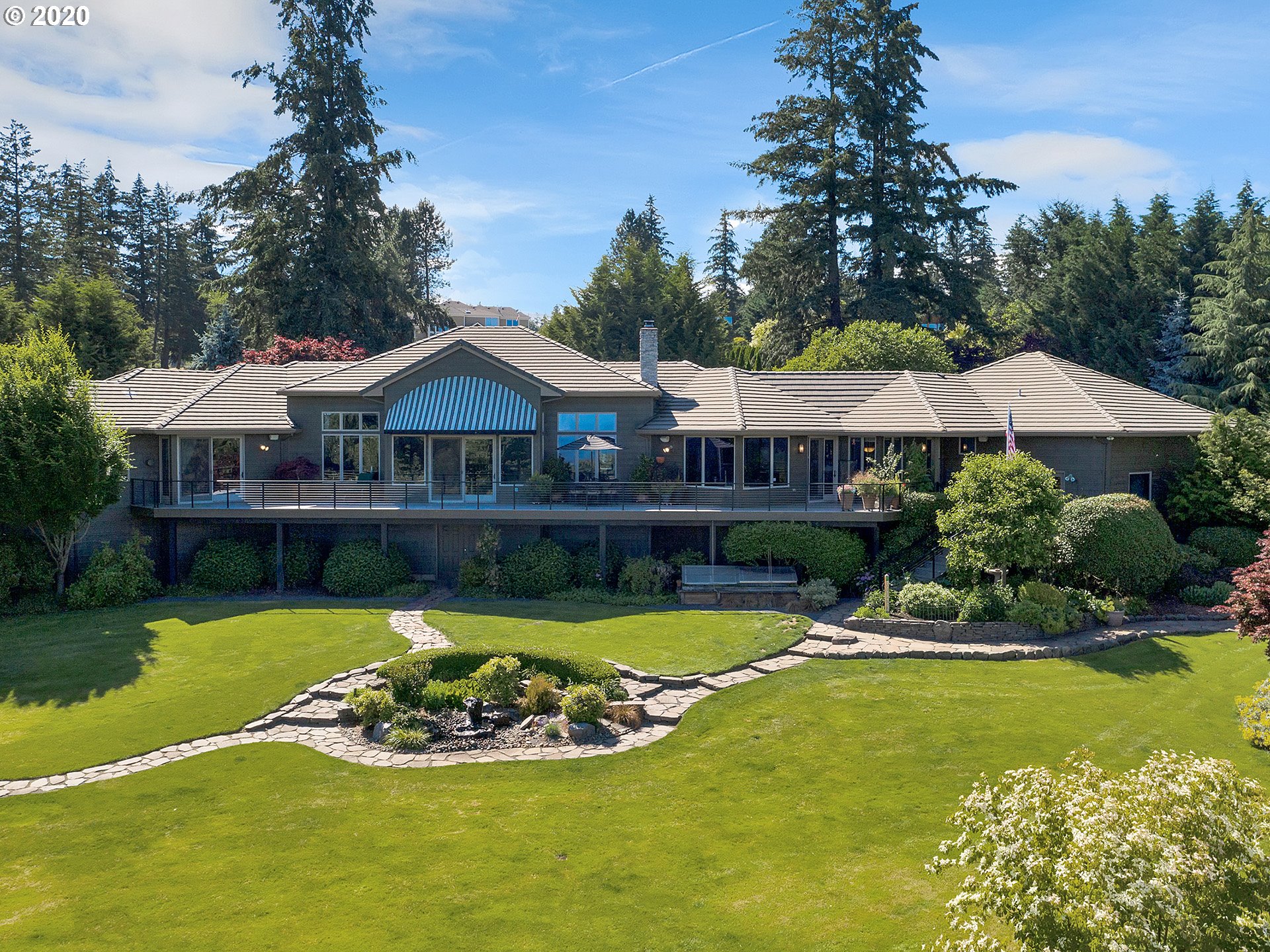 27019 Southwest Ladd Hill Road Sherwood, OR 97140 - Photo 1 of 32 a view of a swimming pool with lawn chairs under an umbrella