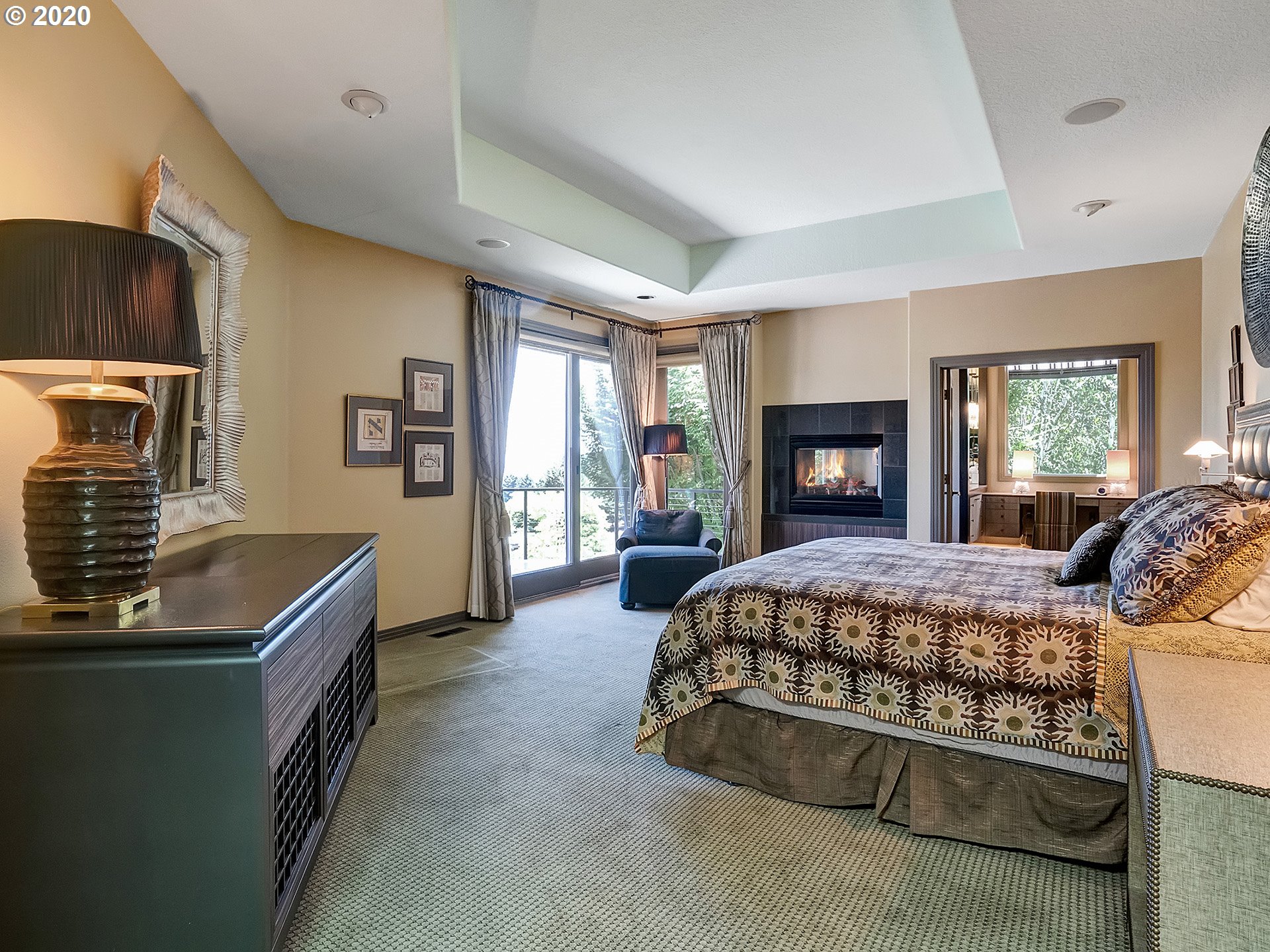 27019 Southwest Ladd Hill Road Sherwood, OR 97140 - Photo 16 of 32 a bed room with a bed and a fireplace