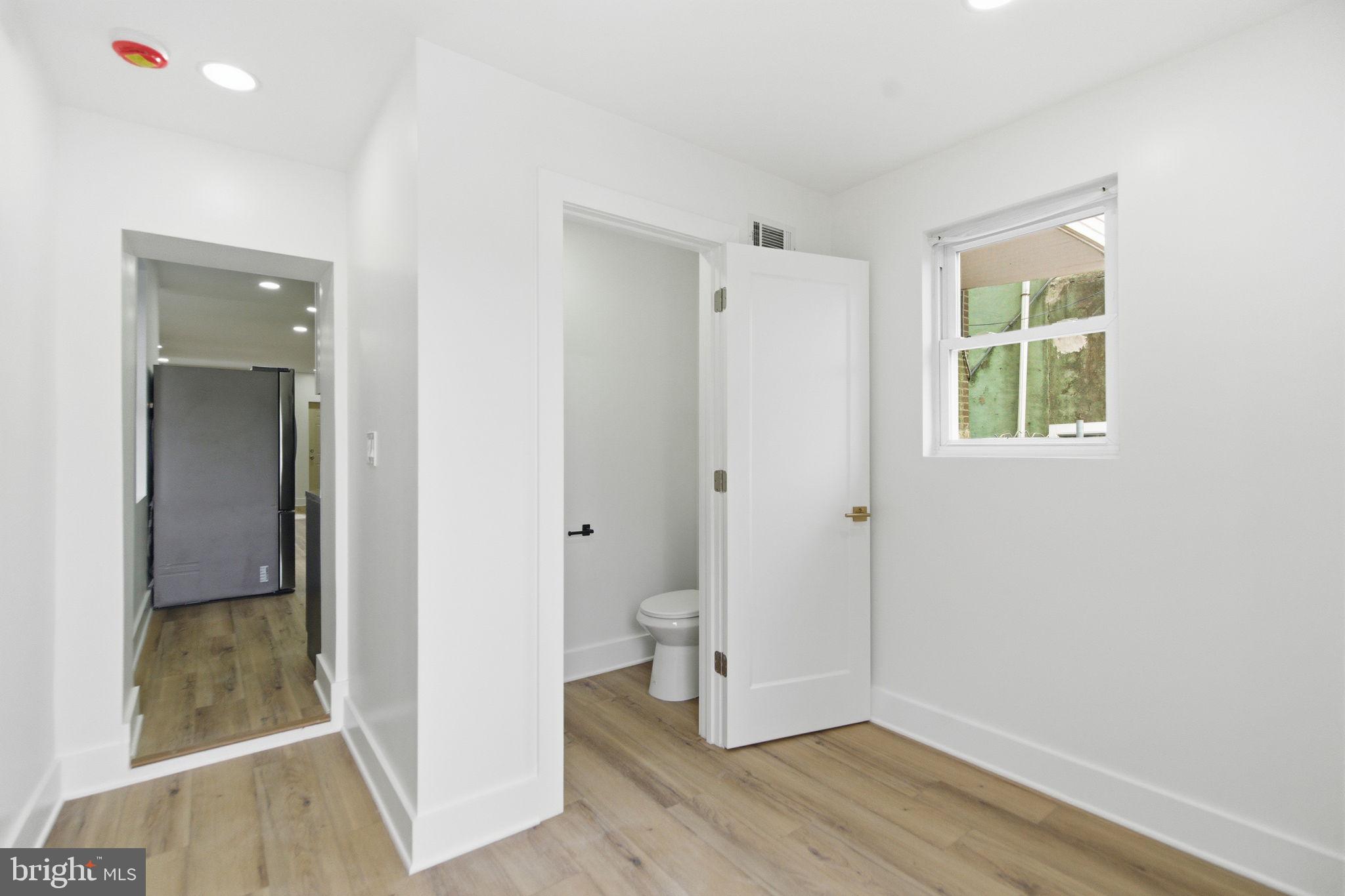 4662 James Street Philadelphia, PA 19137 - Photo 11 of 32 a view of an empty room with wooden floor and a window