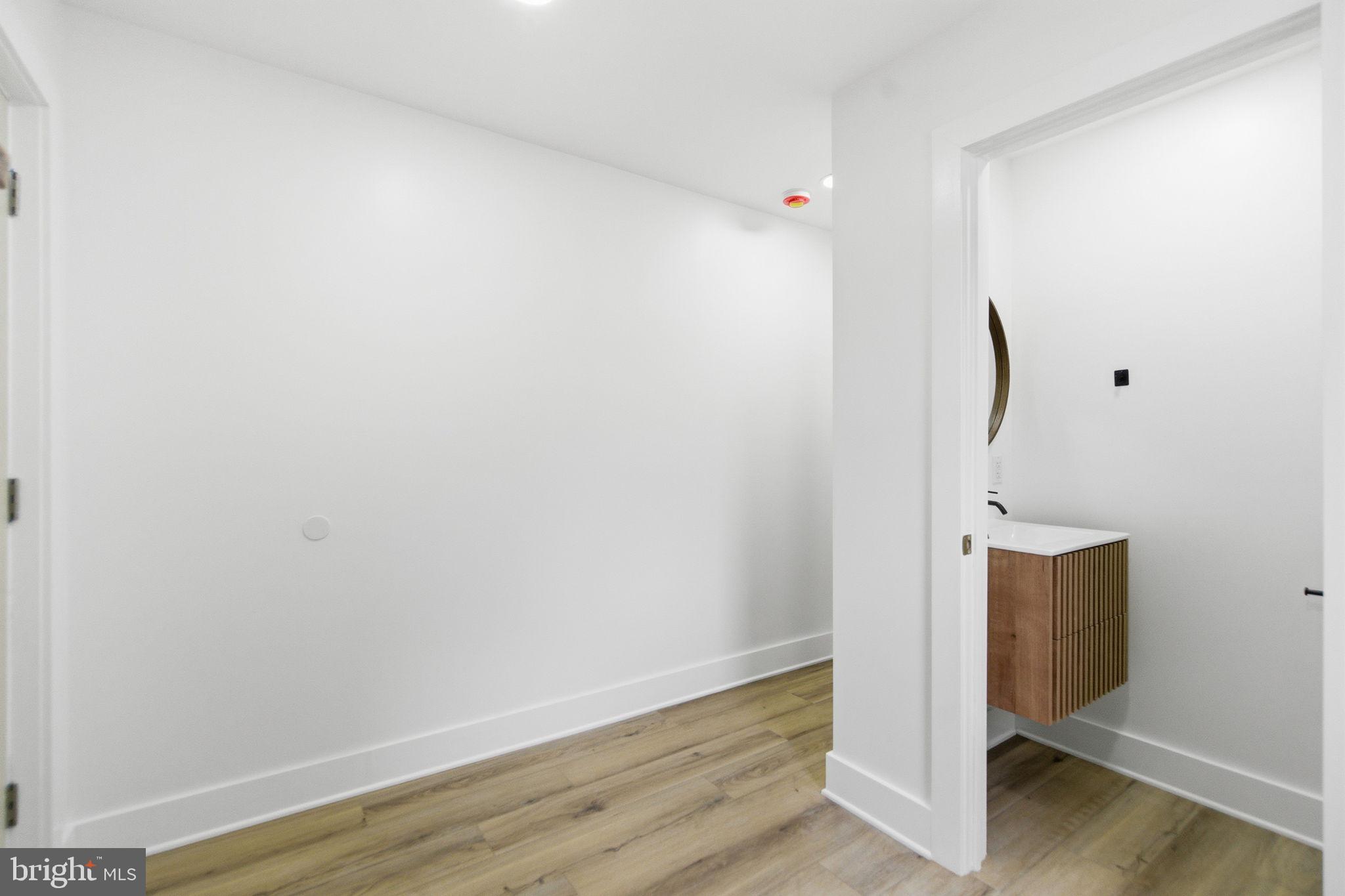4662 James Street Philadelphia, PA 19137 - Photo 12 of 32 a view of an empty room with wooden floor and a window