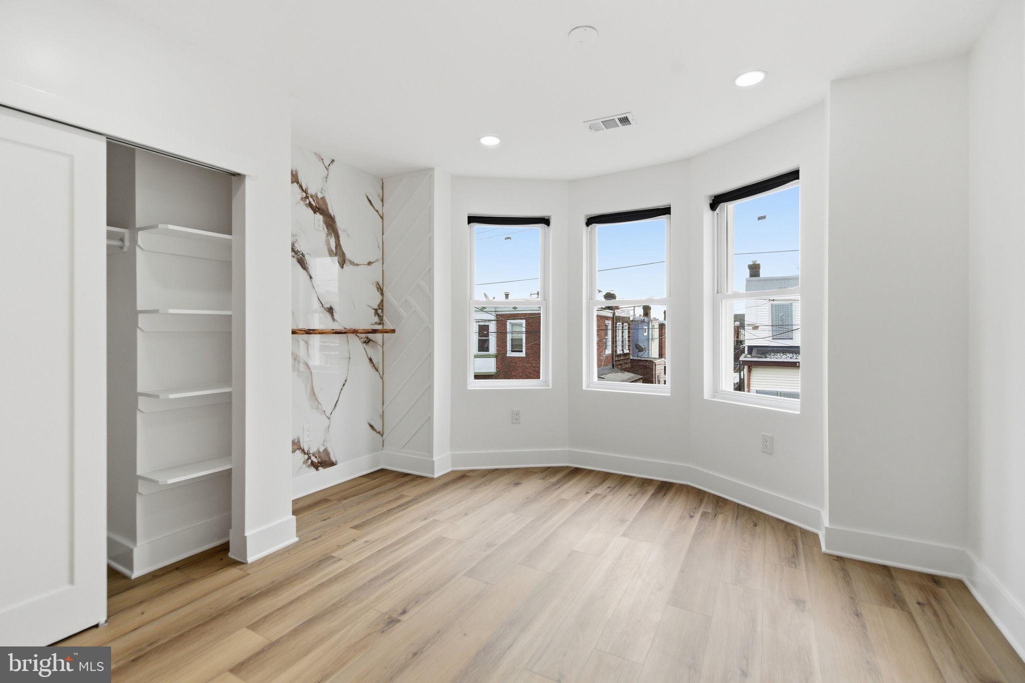 4662 James Street Philadelphia, PA 19137 - Photo 17 of 32 an empty room with wooden floor and windows