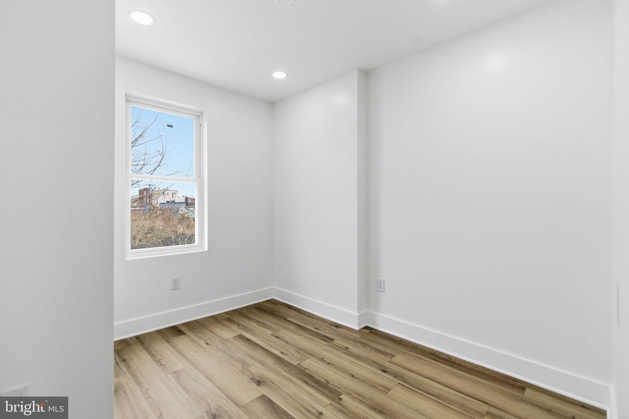 4662 James Street Philadelphia, PA 19137 - Photo 23 of 32 a view of an empty room with wooden floor and a window