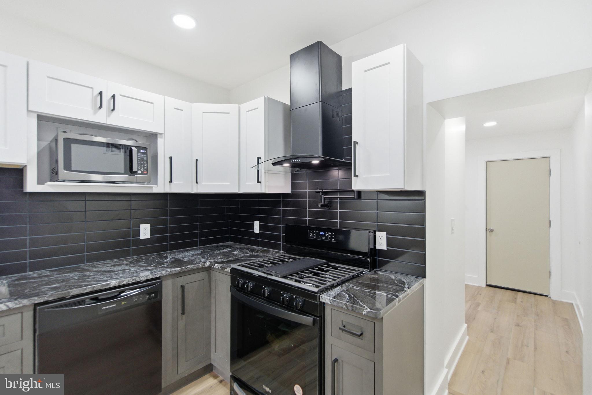 4662 James Street Philadelphia, PA 19137 - Photo 10 of 32 a kitchen with granite countertop a sink stove and cabinets