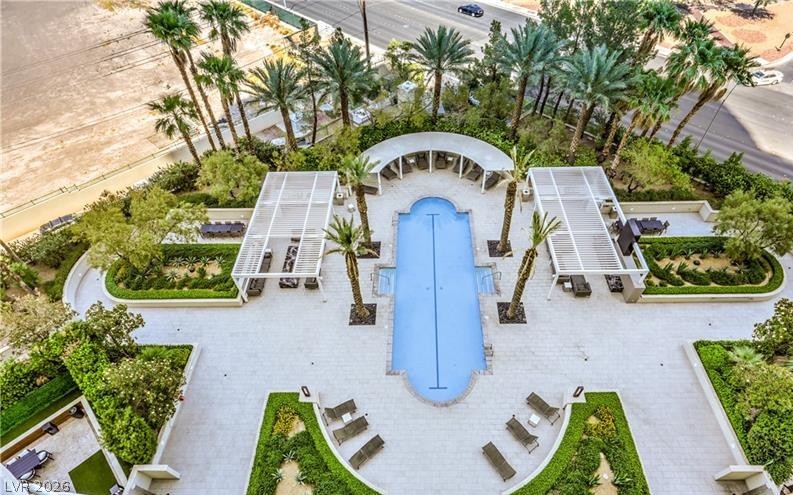2777 Paradise Road, Unit 807 Las Vegas, NV 89109 - Photo 54 of 61 An inviting pool area surrounded by lush greenery, perfect for relaxation and outdoor enjoyment.