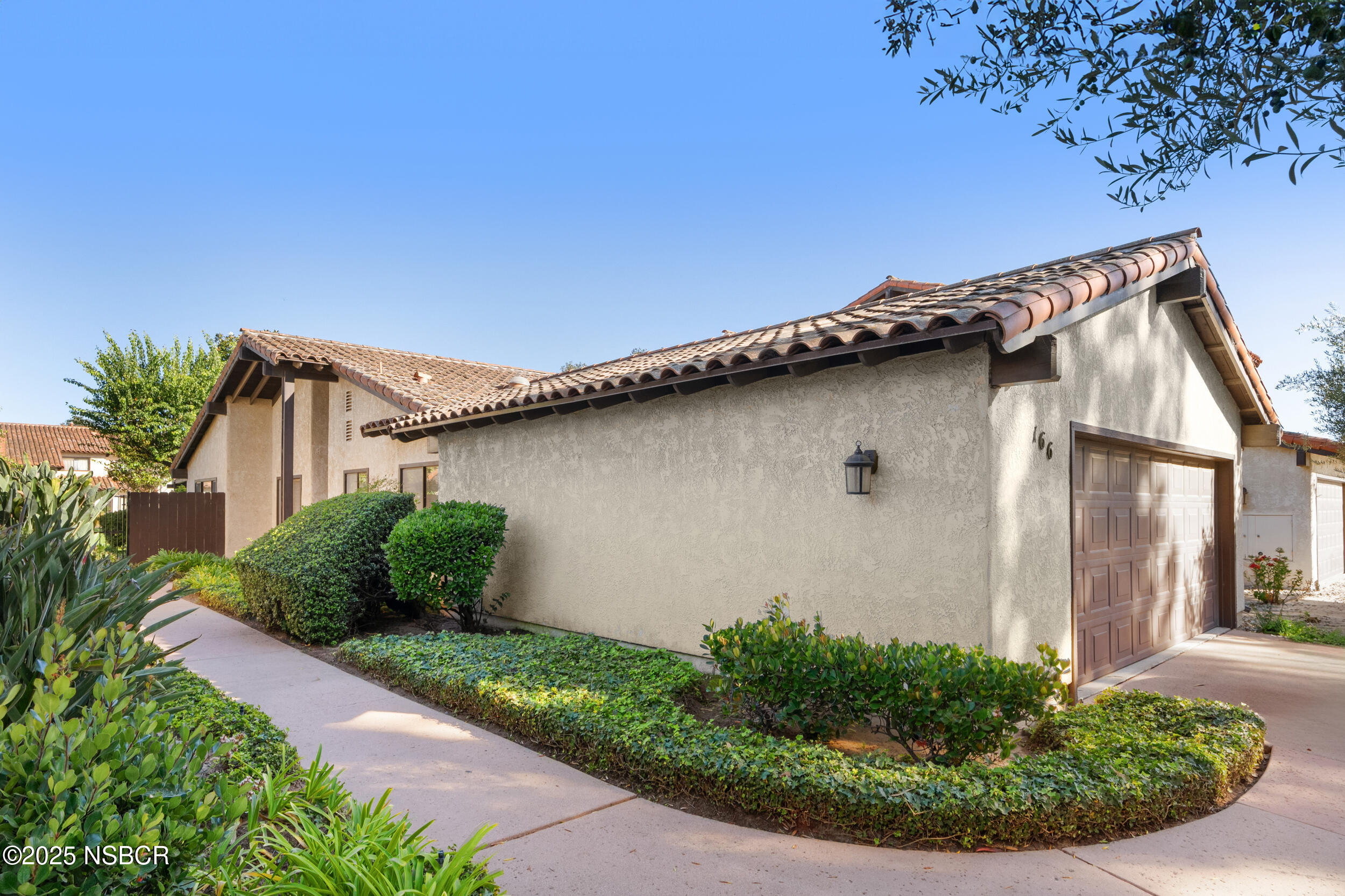 166 Tallyho Road Santa Maria, CA 93455 - Photo 2 of 46 a house with a flower garden in front of it