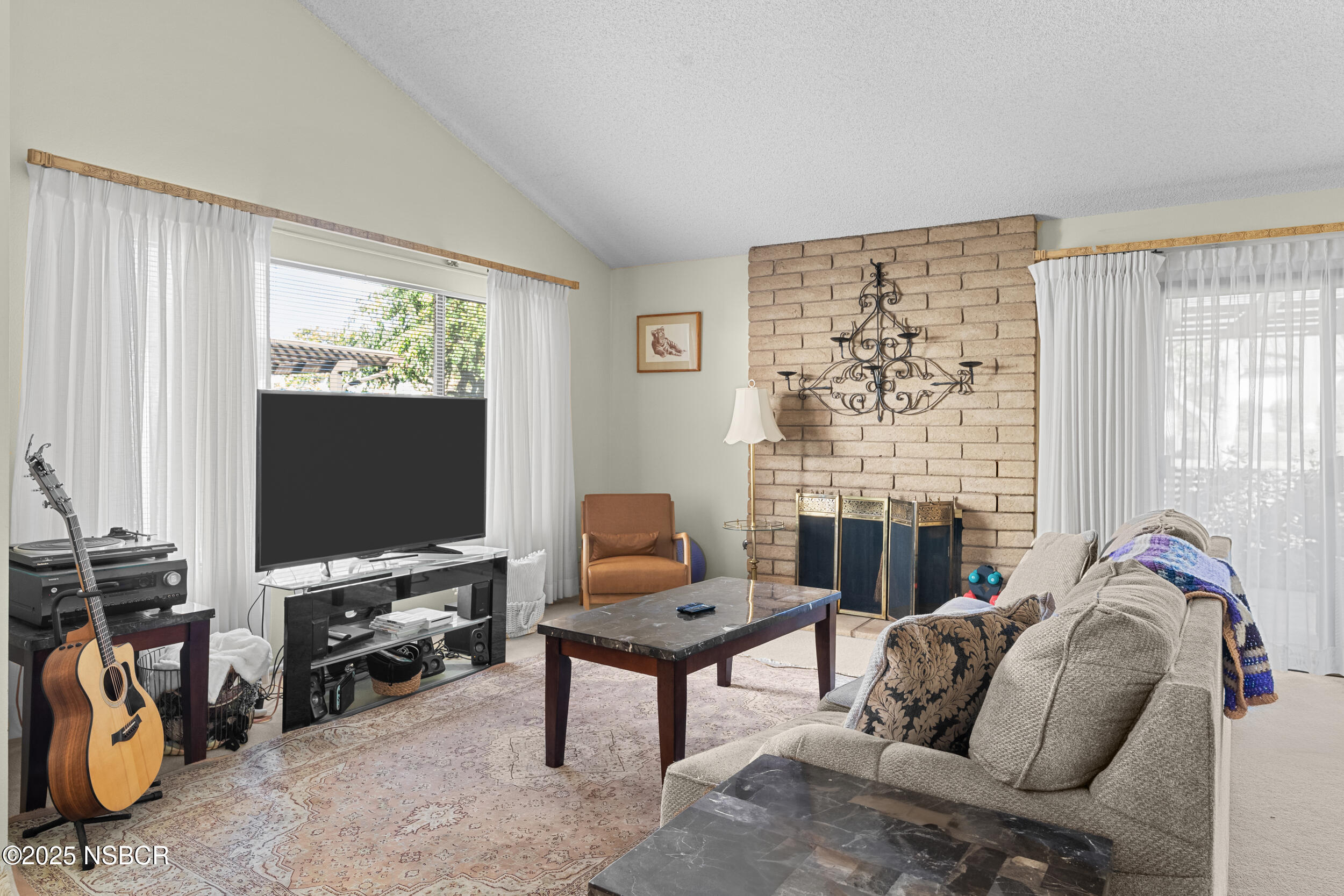 166 Tallyho Road Santa Maria, CA 93455 - Photo 4 of 46 a living room with furniture a fireplace and a flat screen tv