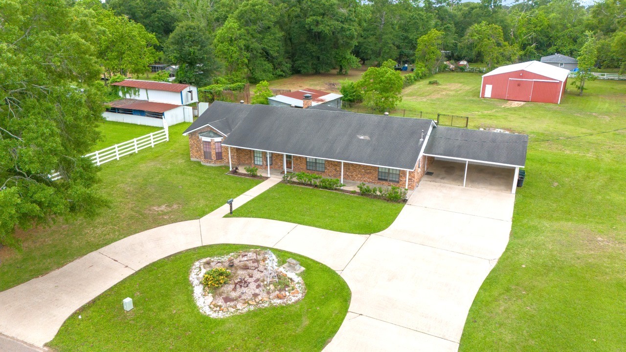 13180 Morgan Drive Splendora, TX 77372 - Photo 33 of 38 Plenty of parking room for family and friends. Huge barn with stalls, stud pen, storage shed, and horse walker.