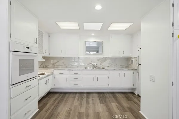 a bathroom with a granite countertop sink mirror and shower
