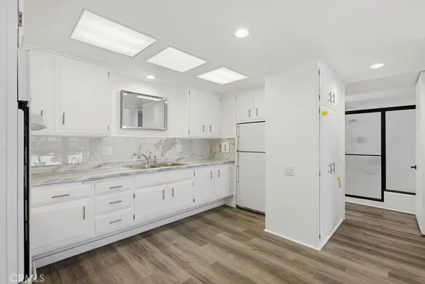 a kitchen with a refrigerator and a sink